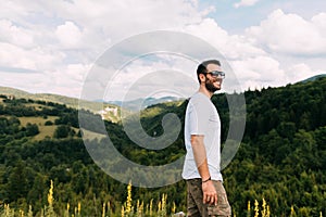 Young male explorer on top of mountain range