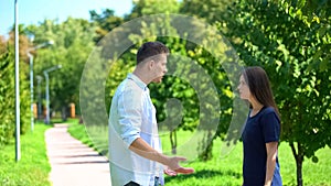 Young male and female arguing outdoors, couple misunderstanding, breakup crisis
