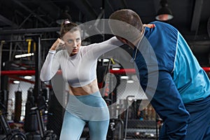 Young male and female couple sparring at sport gym
