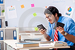 The young male financial manager working in the office