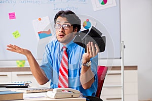 Young male financial manager working in the office