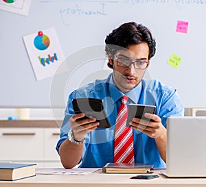 Young male financial manager working in the office