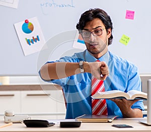 Young male financial manager working in the office