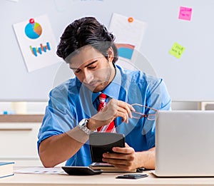 Young male financial manager working in the office