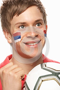 Young Male Football Fan With Serbian Flag Painted