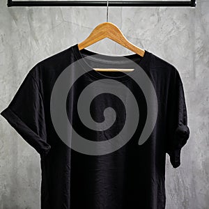 Young male in front blank black t-shirt Roll up sleeves template, Three color black white gray hang on cement background for your