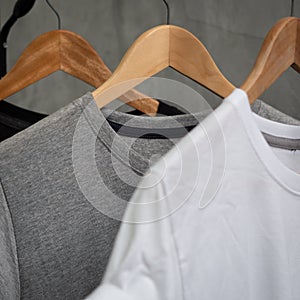 Young male in front blank black t-shirt Roll up sleeves template, Three color black white gray hang on cement background for your