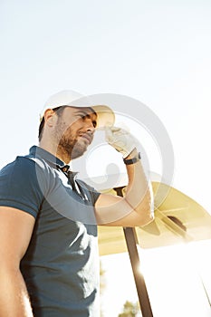 Young male golfer in hat