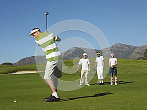 Young Male Golfer Teeing Off