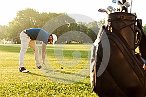 Young male golfer warming up before the game