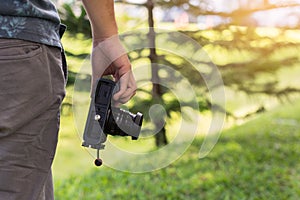 Young male hand holding camera, Photographer concept