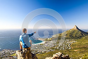 Young male hiker sitting on a rock at Kasteelspoort Hiking Trail in Table Mountain National Park in Cape Town