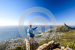 Young male hiker sitting on a rock at Kasteelspoort Hiking Trail in Table Mountain National Park in Cape Town