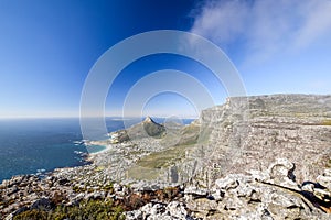 Young male hiker sitting on a rock at Kasteelspoort Hiking Trail in Table Mountain National Park in Cape Town