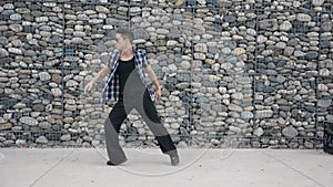 Young male hip-hop dancer dancing outside