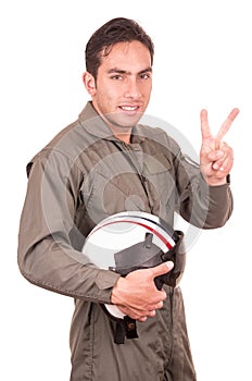 Young male hispanic pilot holding helmet