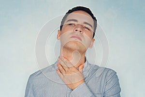 Young male holding the neck. sore throat. dry throat, patient with colds or flu. concept of health and medicine