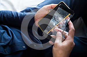 Young male holding smartphone and broken of tempered glass  film screen.protection and gadget