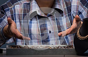 Young male jeweller working at night in his workshop