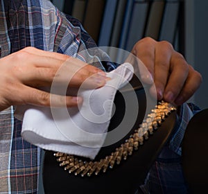 Young male jeweller working at night in his workshop