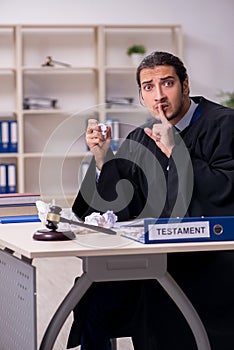 Young male judge working in courthouse