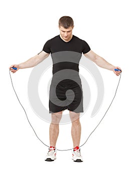 Young male jumping isolated at white background