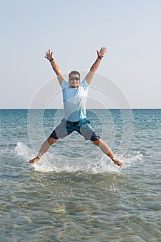 Young male jumping from the water