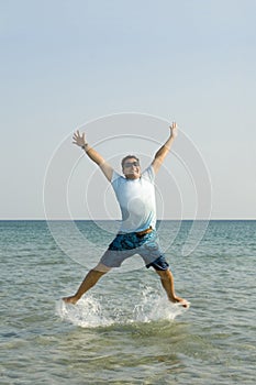 Young male jumping from the water