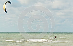 Young, male kiteboarding at a tropical beach