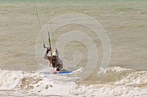 Young, male kitebording in tropical water