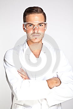 Young male lab assistant with protective glasses