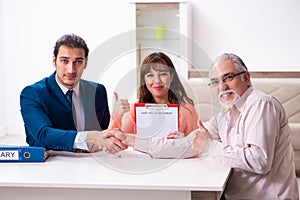 Young male lawyer, old man and his granddaughter in testament co