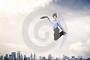 Young male leaping in the air with his briefcase