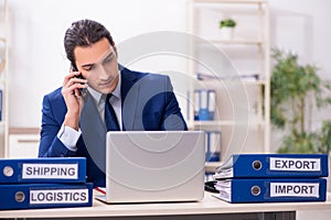 Young male logistics specialist working in the office