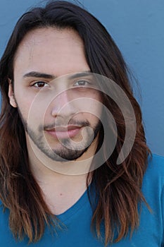 Young male with long hair and beard posing to the camera