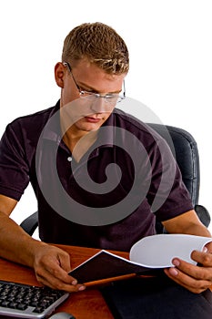 Young male looking in to book