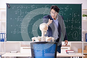 The young male math teacher and student skeleton