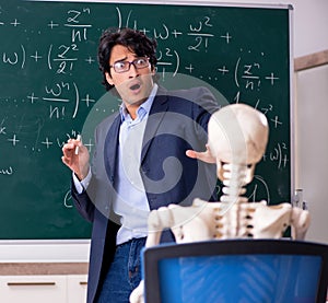 Young male math teacher and student skeleton