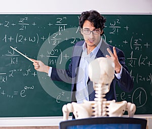 Young male math teacher and student skeleton