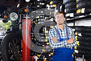 Young male mechanic working in auto repair shop