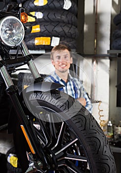 Young male mechanic working in auto repair shop