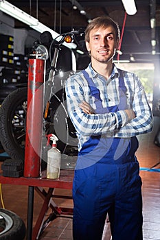 Young male mechanic working in auto repair shop