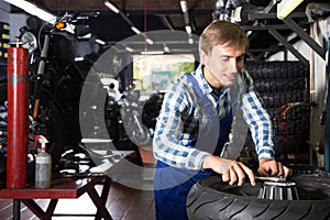 Young male mechanic working in auto repair shop