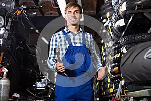 Young male mechanic working in auto repair shop