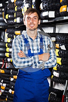 Young male mechanic working in auto repair shop