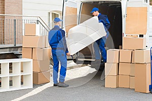 Movers Unloading Sofa From Truck photo