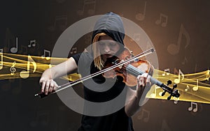 Musician playing on violin with notes around photo