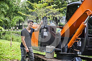 Young male near constructing machine photo