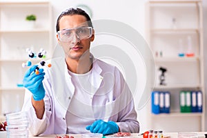 Young male nutrition expert testing food products in lab