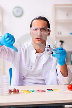 Young male nutrition expert testing food products in lab